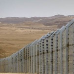 Egyptian border guards (R) observe from